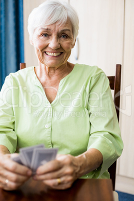 Senior woman playing cards