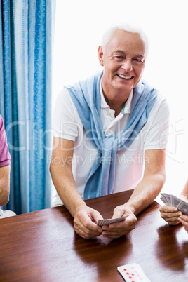 Senior man playing cards