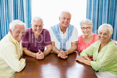 Smiling seniors sitting at table