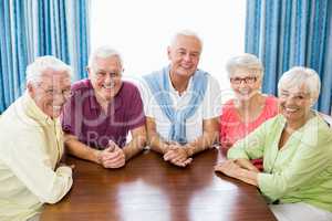Smiling seniors sitting at table