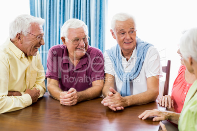 Seniors talking at table