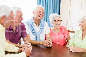 Seniors talking at table