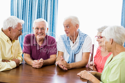 Seniors talking at table