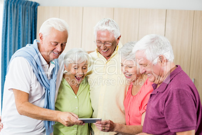 Seniors looking at smartphone