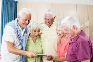 Seniors looking at smartphone