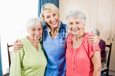 Smiling nurse and senior women standing