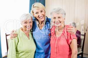 Smiling nurse and senior women standing