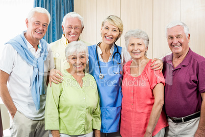 Seniors and nurse standing in a row