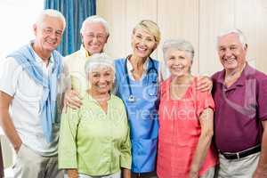 Seniors and nurse standing in a row