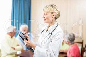 Nurse writing on clipboard