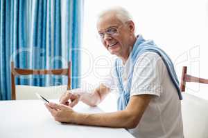 Senior man using a tablet