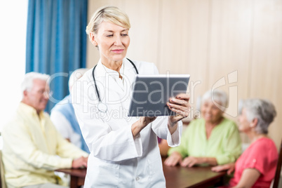 Nurse using a tablet standing
