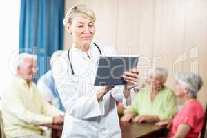 Nurse using a tablet standing