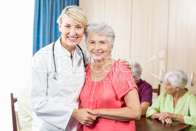 Nurse and senior woman hugging