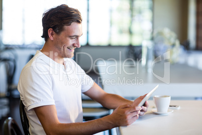 Happy man using digital tablet