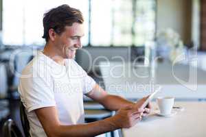 Happy man using digital tablet