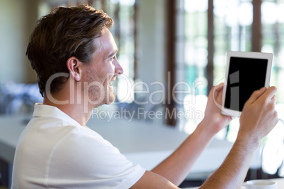 Happy man using digital tablet