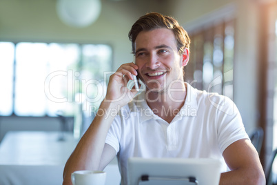 Smiling man talking on mobile phone