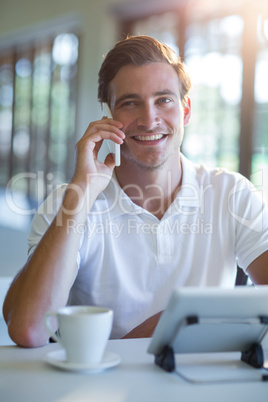 Smiling man talking on mobile phone