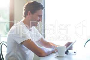 Smiling man using digital table