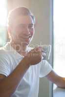 Portrait of smiling man having cup of coffee