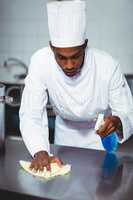 Chef cleaning kitchen counter