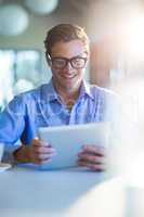 Smiling man using digital tablet