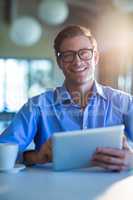 Portrait of smiling man using digital tablet