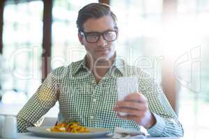 Man using mobile phone while having a lunch
