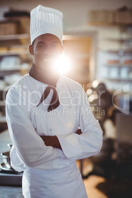 Portrait of happy chef standing with arms crossed