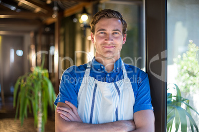 Portrait of happy chef standing with arms crossed