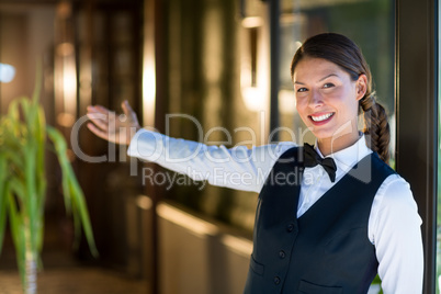 Portrait of smiling waitress welcoming