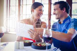 Happy couple using a digital tablet during lunch