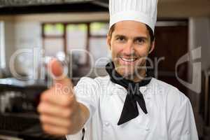 Portrait of smiling chef showing thumbs up