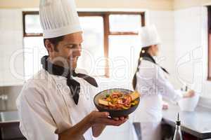 Happy head chef presenting his food