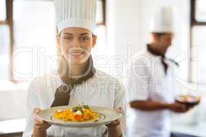Happy head chef presenting her food