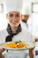 Happy head chef presenting her food