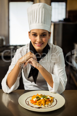 Happy head chef presenting her food