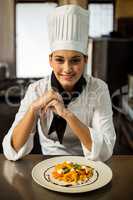 Happy head chef presenting her food