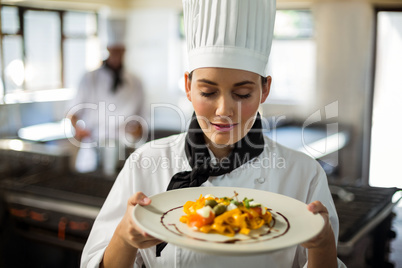 Head chef with eyes closed smelling food
