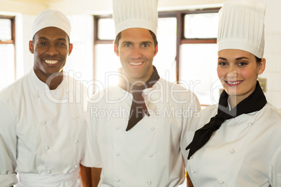 Portrait of three chefs in commercial kitchen