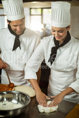 Two head chef making pizza dough