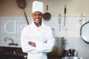 Portrait of happy chef standing with arms crossed