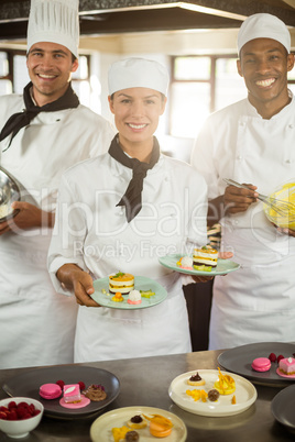 Portrait of chefs preparing a dessert