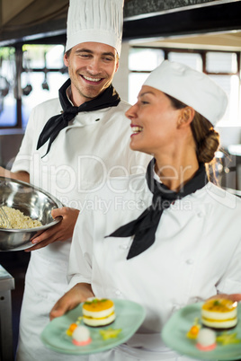 Close-up of chefs smiling while working in kitchen