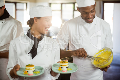 Female chef presenting dessert plates