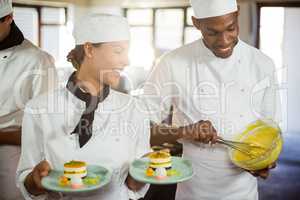 Female chef presenting dessert plates