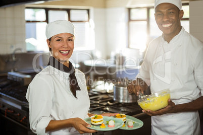 Female chef presenting dessert plates