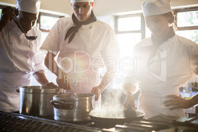 Chefs preparing food at stove