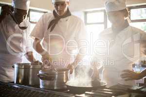 Chefs preparing food at stove